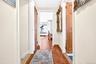 Extra Wide 2nd Floor Hallway, featuring hardwood flooring and entries to the 3rd and 4th Bedrooms and Bathroom.