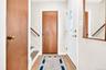 Spacious and inviting entry hall, featuring hardwood flooring and coat closet.