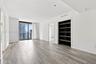 Wood-finish flooring, floor-to-ceiling glass sliding doors, built-in shelving, and recessed lighting