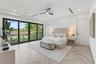Interior space featuring chevron-patterned wood-finish flooring, floor-to-ceiling multi-panel sliding glass doors, recessed lighting, and a modern bla