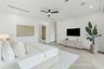 Herringbone-patterned wood-finish flooring, recessed linear lighting, and integrated ceiling speakers