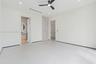 Neutral interior featuring large-format tile flooring, built-in floor-to-ceiling cabinetry, recessed lighting, and a modern three-blade ceiling fan