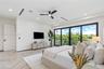 Herringbone-patterned wood-finish flooring, floor-to-ceiling glass sliding doors, recessed lighting, ceiling fan with integrated light, and built-in c
