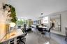 Open-concept living area featuring large-format tile flooring, a modern circular multi-ring chandelier, and floor-to-ceiling glass sliding doors openi
