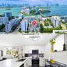 Aerial perspective featuring a mid-rise residential structure in a coastal urban setting, complemented by a kitchen interior with white shaker-style c