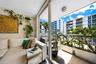 Covered balcony with floor-to-ceiling sliding glass doors, flush-mount lighting, and metal railing