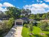 New construction single-story home with an attached garage, modern garage door, and a striking geometric-pattern driveway