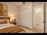 Bright, versatile bedroom with clean finishes, easy-care tile flooring, and a bi-fold closet