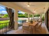 Covered patio made for year-round outdoor living, with three lighted ceiling fans, overlooking the pool and fenced backyard