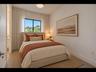 Serene bedroom with a large black-framed window, floor-to-ceiling drapery, and calming neutral tones