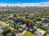 Bird's-eye view of the single-story home with private pool, driveway, and mature landscaping