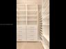 Custom floor-to-ceiling built-in storage with integrated drawers and polished hardware — a place for everything