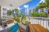 Covered balcony featuring concrete flooring and a white metal safety railing