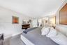 Wall-mounted electric fireplace, grey tile flooring, and neutral wall tones
