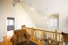 Sitting room featuring ceiling fan, light wood-style flooring, and lofted ceiling