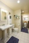 Bathroom with curtained shower, light tile patterned flooring, and recessed lighting