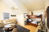 Bedroom featuring light wood-type flooring, ceiling fan, and lofted ceiling