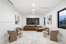 High ceilings with recessed lighting, smooth-finish walls, and dark-framed windows