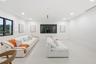 Minimalist interior space featuring large-format tile flooring, recessed ceiling lighting, and expansive windows with dark frames