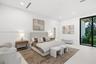 Neutral color palette featuring smooth interior walls, expansive floor-to-ceiling glass panel door, recessed lighting, and continuous polished floorin