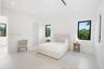 Minimalist interior space featuring large-format tile flooring, recessed ceiling lighting, and black-framed windows