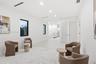 Open-concept interior space featuring recessed ceiling lighting, smooth-finish walls, high-contrast window frames, and linear ceiling registers