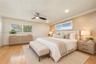 Wood-finish flooring, recessed lighting, ceiling fan with integrated light, horizontal window shutters, and textured wall finish
