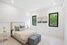 Bright room featuring neutral wall color, recessed lighting, and two windows with black frames