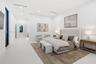 Minimalist interior featuring smooth-finish flooring, recessed linear lighting, and floor-to-ceiling windows