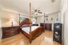 Wood-finish flooring, crown molding, and ceiling fan with integrated lighting