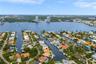 Aerial perspective of a waterfront residential enclave featuring deep-water canal access, private boat slips, and direct waterway frontage
