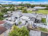 Single-story exterior featuring a hip roof, exterior storage shed, covered outdoor space, and fenced perimeter