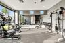 Fitness room featuring floor-to-ceiling windows, full-wall mirrors, recessed lighting, and resilient flooring