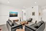Open-concept interior featuring large-format tile flooring, recessed lighting, and solid-core interior doors