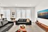 Open-concept space featuring large-format tile flooring, recessed ceiling lighting, and floor-to-ceiling windows