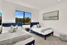 Room featuring large-format tile flooring, recessed lighting, and a window with exterior scenery