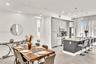 Kitchen featuring slab-front cabinetry, a quartz-topped center island with bar seating, stainless steel appliances, recessed lighting, and large-forma