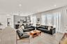 Open-concept interior featuring large-format tile flooring, recessed lighting, and expansive floor-to-ceiling windows