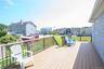 Expansive outdoor deck with wood-finish flooring and wooden railing