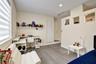 Room featuring wood-finish flooring, recessed lighting, and a half-height wall partition with three integrated display niches