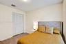 Room featuring wood-finish flooring and a bi-fold louvered closet door