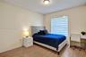 Wood-finish flooring, neutral wall tones, and tiered window shades