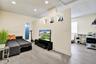 Interior space featuring wood-finish flooring, recessed lighting, and a partial partition wall with built-in decorative niches