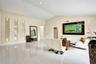 Vaulted ceilings, large-format tile flooring, and integrated recessed wall niches with accent lighting