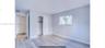 Neutral interior featuring wood-finish flooring, sliding closet doors, and a horizontal window