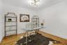 Room featuring wood-finish flooring and a multi-arm modern geometric chandelier