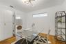 Wood-finish flooring, built-in floor-to-ceiling cabinetry, horizontal clerestory window, and multi-arm chandelier