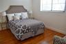 Vertical board-and-batten wall detailing, polished wood-finish flooring, and horizontal window blinds