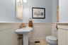 The wainscoting and detailing set this half bath apart.