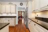 The counter and cabinets on the right remind me of a butler's pantry.  And this one is yours!